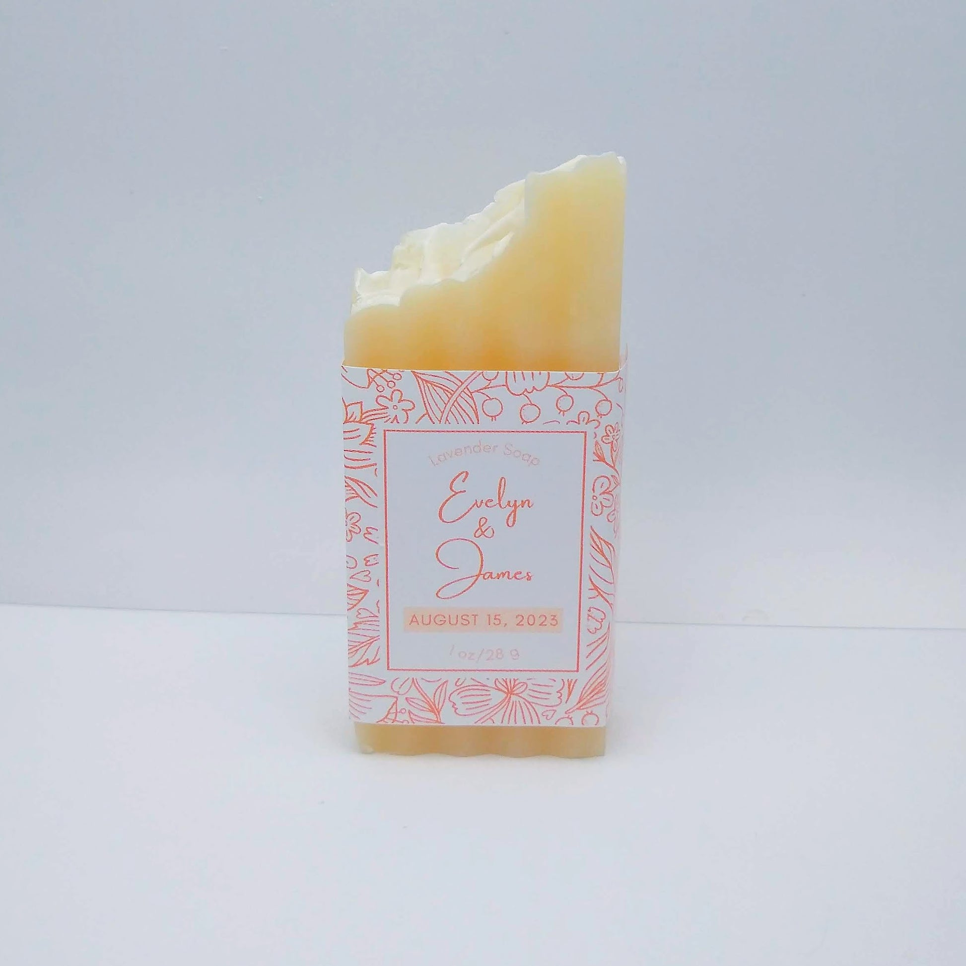A mini bar of cream-colored soap with a light orange label printed with Evelyn & James, August 15, 2023.