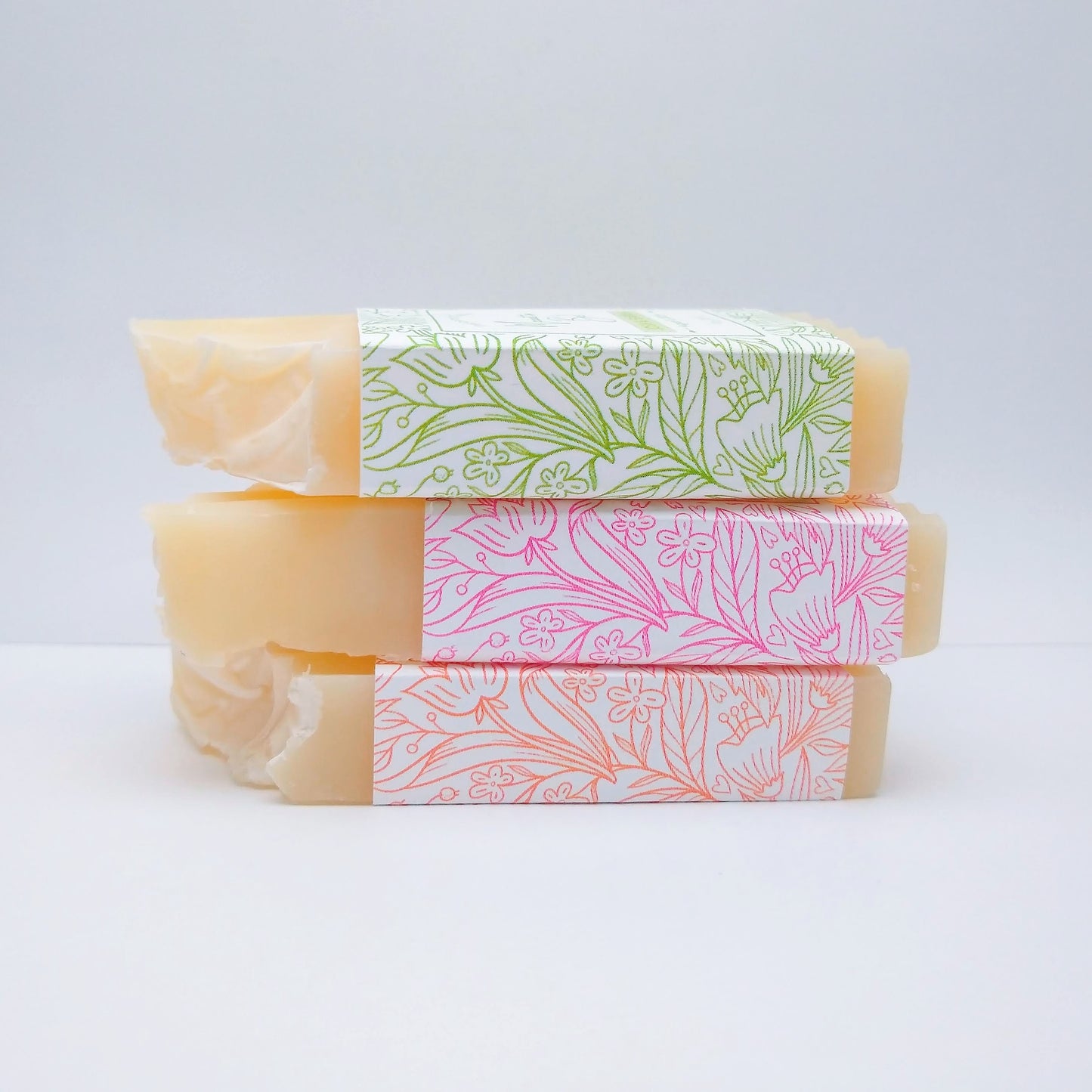 3 mini cream-colored stacked on top of each other long ways with green, pink, and orange labels on a white background.