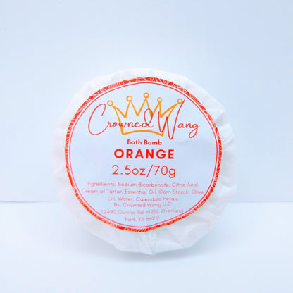 Crowned Wang brand 2.5oz orange bath bomb with orange and white label. The label also includes a yellow crown outline.